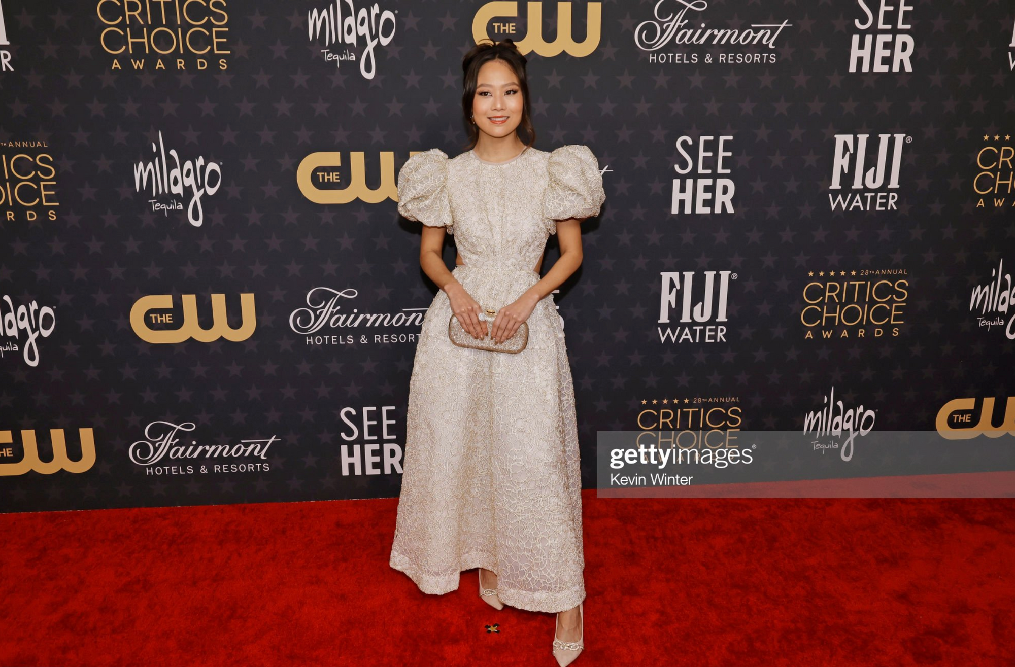 GettyImage, Krista Marie Yu at Critics Choice Award holding Bella Rosa Clutch.