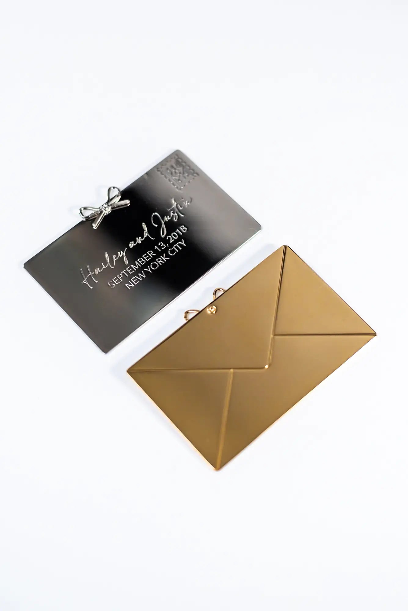 A gold envelope-shaped card holder featuring a black wedding invitation reading "Hailey and Justin, September 14, 2018, New York City" is tucked inside. A personalized message from The Bella Rosa Collection's Personalized Plaque Sentiment Engraving adds elegance, transforming it into a cherished keepsake.