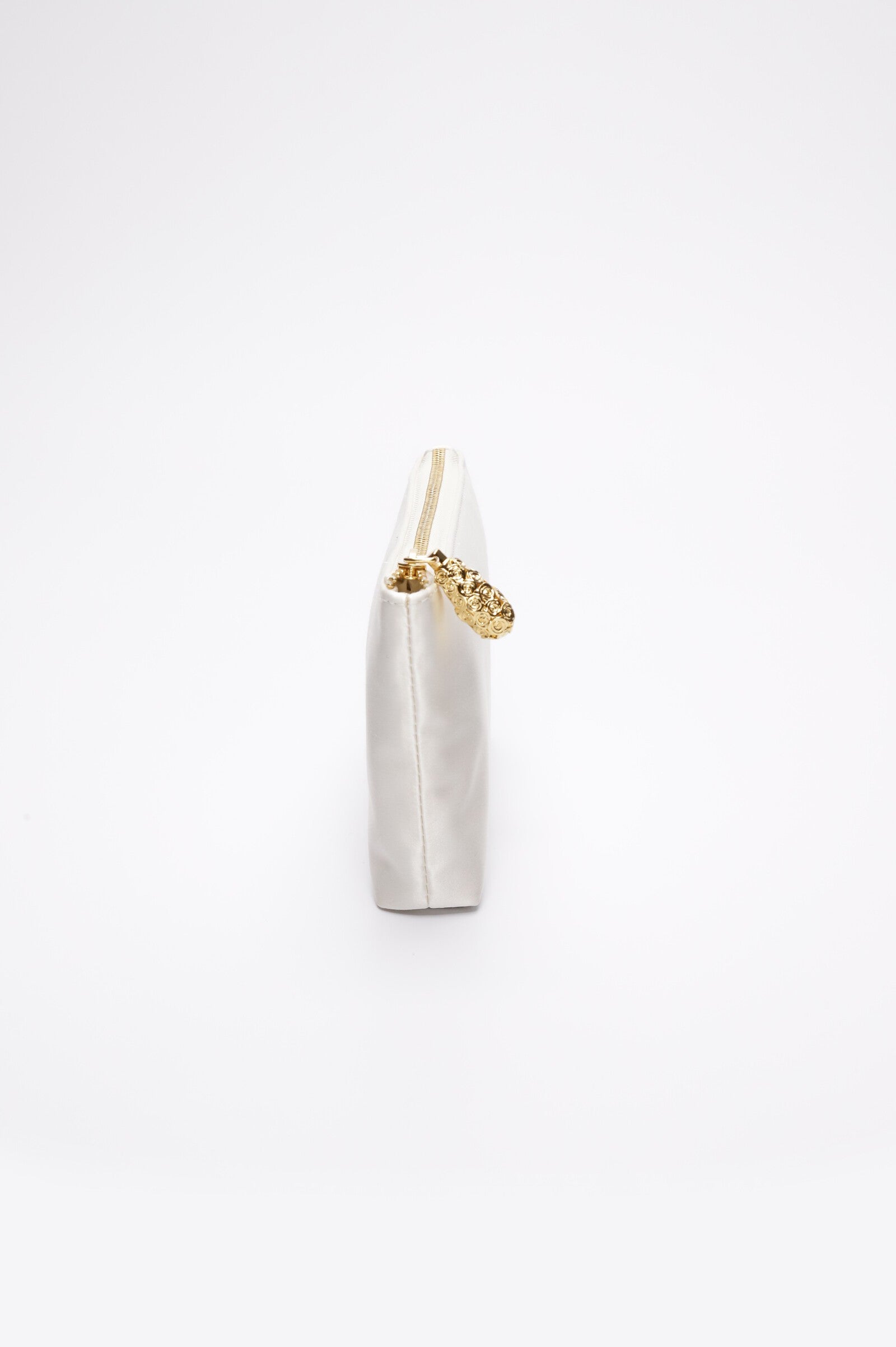 Showcasing the Mia Clutch from The Bella Rosa Collection, this clear acrylic accessory features an embroidered bridal crest and an ivory satin zipper pouch with a gold pull. Its sleek, elegant design offers three-in-one functionality, perfect for any ensemble against a plain white backdrop.