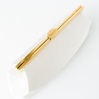 A close up of The Bella Rosa Collection's Rosa Clutch in Ivory Floral Embroidery on a white surface.