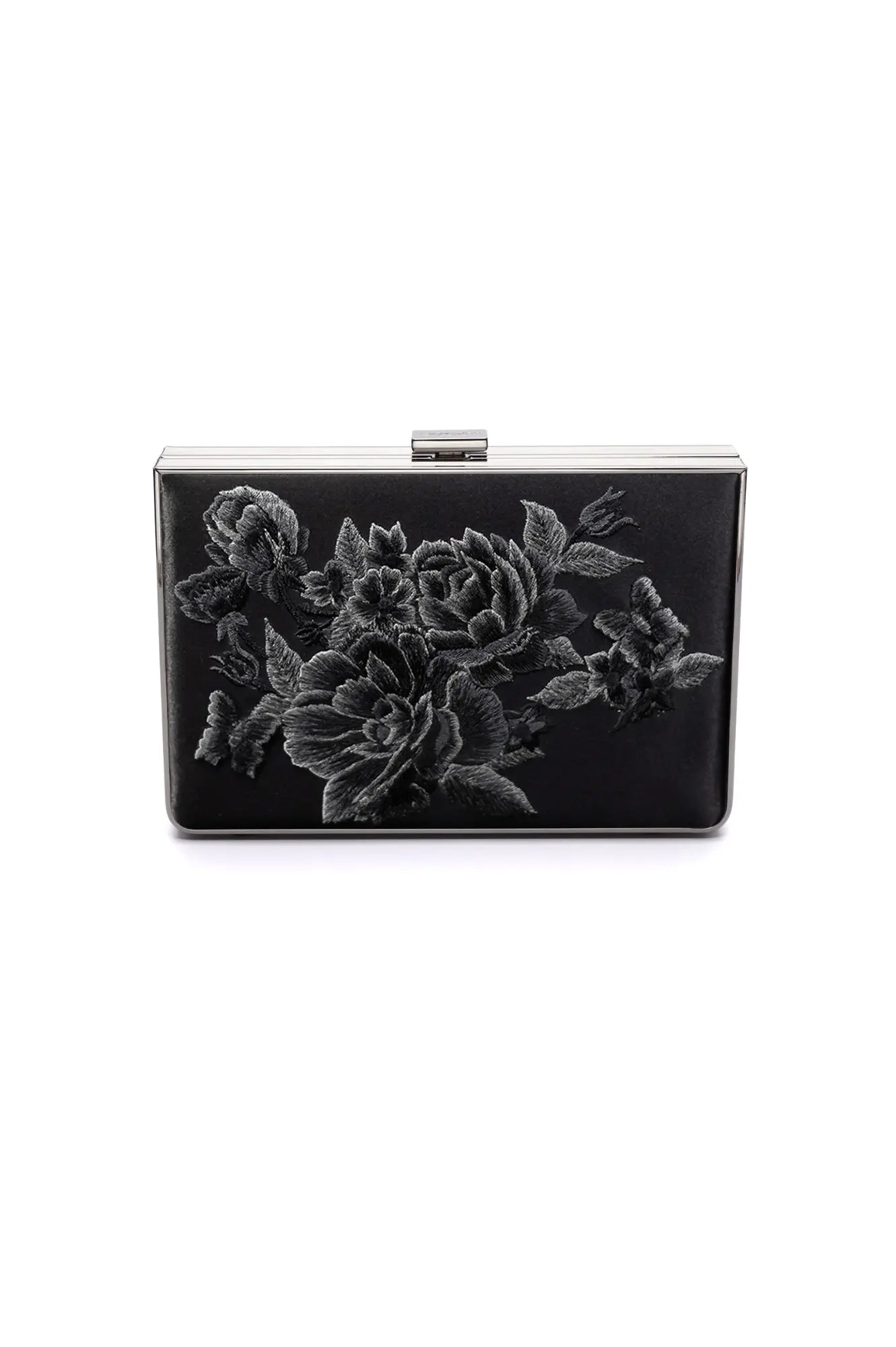 The Bella Rosa Collection's Venezia Clutch x MICAELA Black Satin Floral Embroidery combines a sleek rectangular design with a silver clasp and delicate floral embroidery in shades of gray—available now at our Sample Sale!