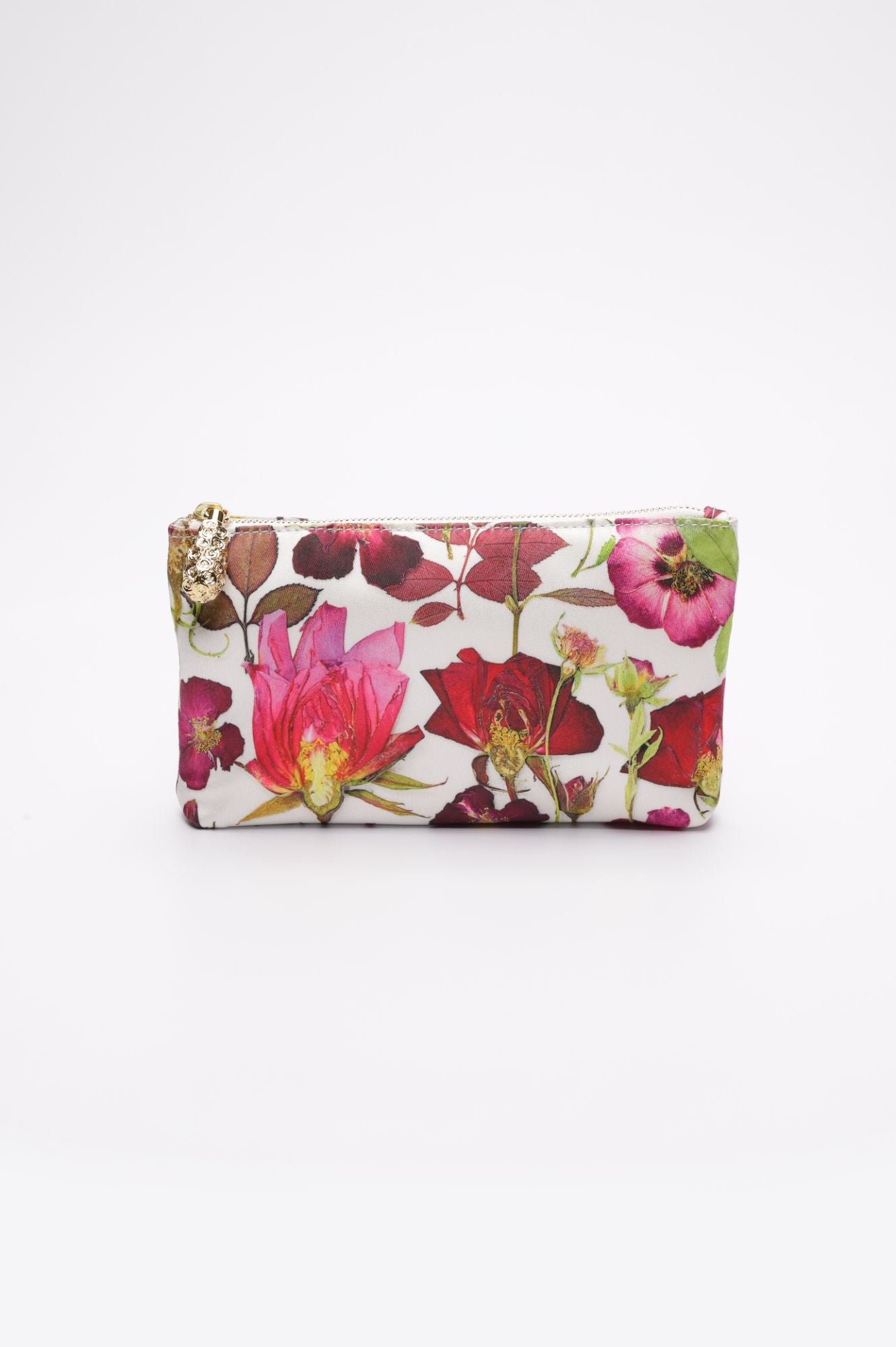 The Mia Fiori Clutch from The Bella Rosa Collection features a white acrylic rectangular design adorned with a pressed flower print showcasing red, pink, and green flowers. This sample sale item combines practicality with elegance and includes an interior floral satin zipper pouch.