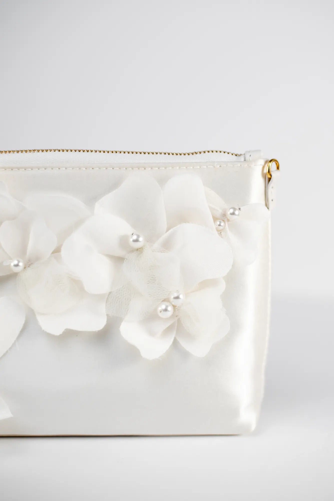 A close-up of the Hayden Clutch Purse Organza Flowers from The Bella Rosa Collection, showcasing exquisite Italian craftsmanship with fabric flower embellishments, pearl accents, a gold zipper, and loop handle attachments.