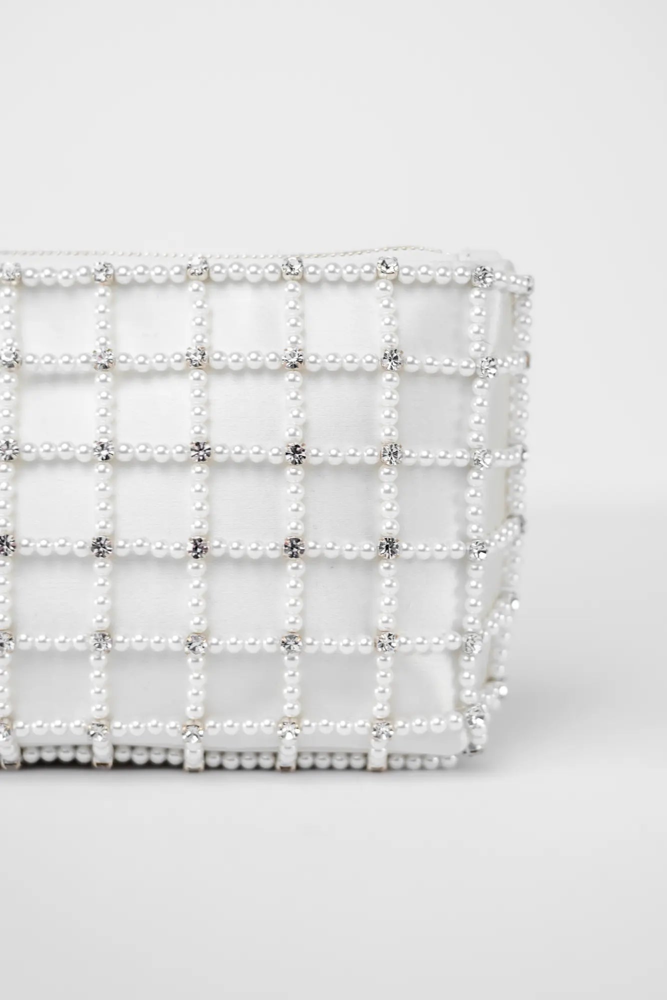 The Bella Rosa Collection Hayden Clutch - Pearl Cage featuring pearl beading and silver accents on a white background, showcasing Italian craftsmanship.