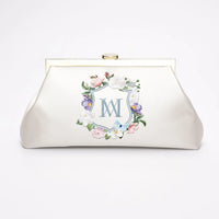 A Bella Rosa Collection Rosa Clutch - Ivory Floral Embroidery with a monogrammed design.