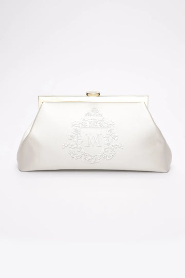 A white vintage bridal clutch with Whyte, monogram embroidery and white, Bridle crest embroidery.