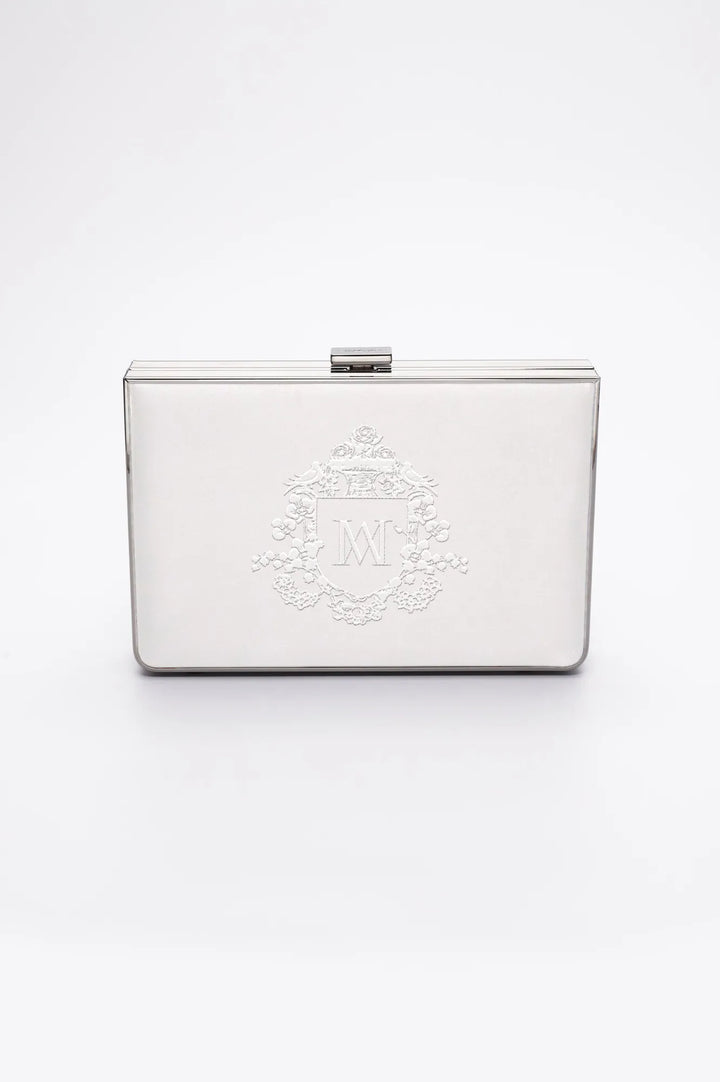The front view of the Venezia clutch in White satin with regal bridal monogram crest embroidery.