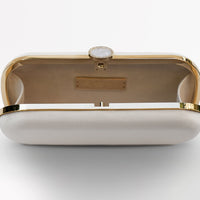 Ivory satin bridal clutch open view with gold hardware accents and a stimulated mother of pearl clasp.