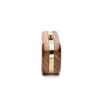 The Bella Rosa Collection Bella Clutch African Zebra Wood Petite with gold-tone clasp, isolated on white background.