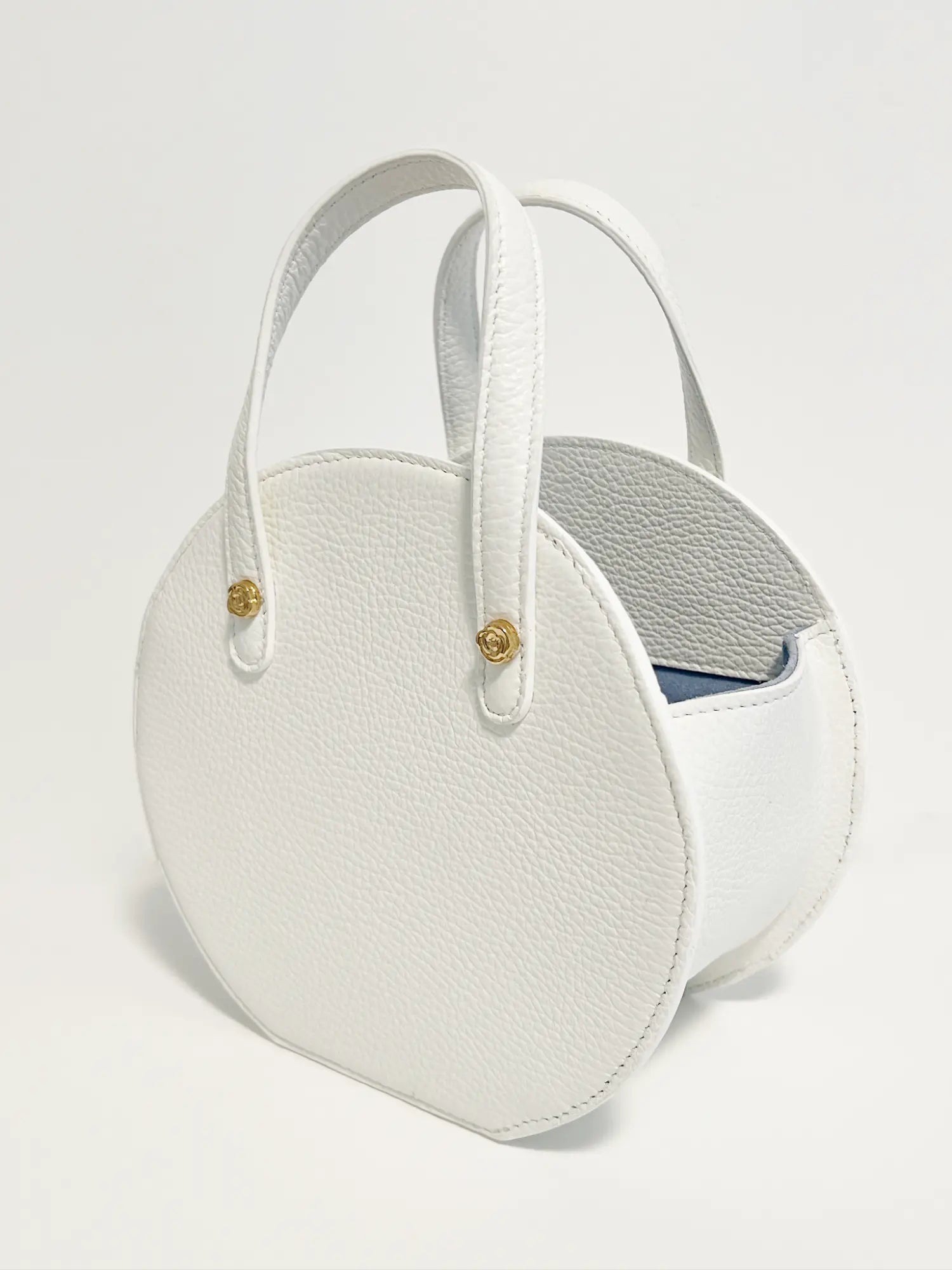White round Harper Hat Box Handbag in Italian leather with short straps on a plain background from The Bella Rosa Collection.