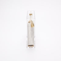 Side view of the clear acrylic Mia body with white satin pouch..