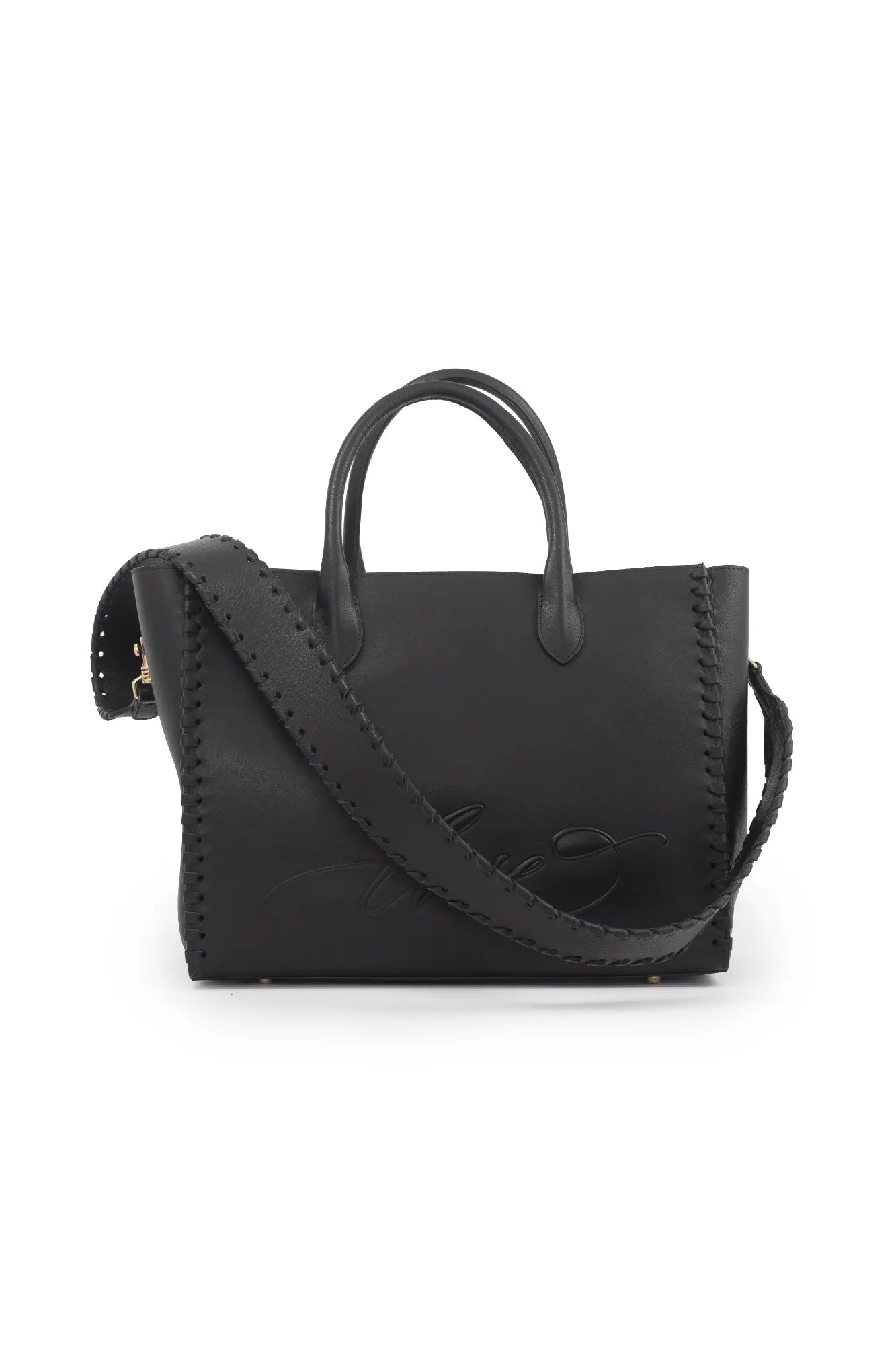 The LOVE Tote - Black by The Bella Rosa Collection is a black leather handbag featuring two handles and a long shoulder strap, complete with stitched edges and embossed detailing—ideal for carrying your wedding day essentials.