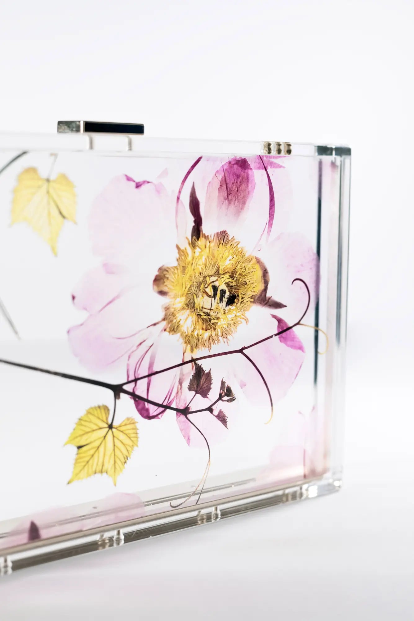 A Mia Acrylic Clutch - Pressed Translucent Floral case from The Bella Rosa Collection.