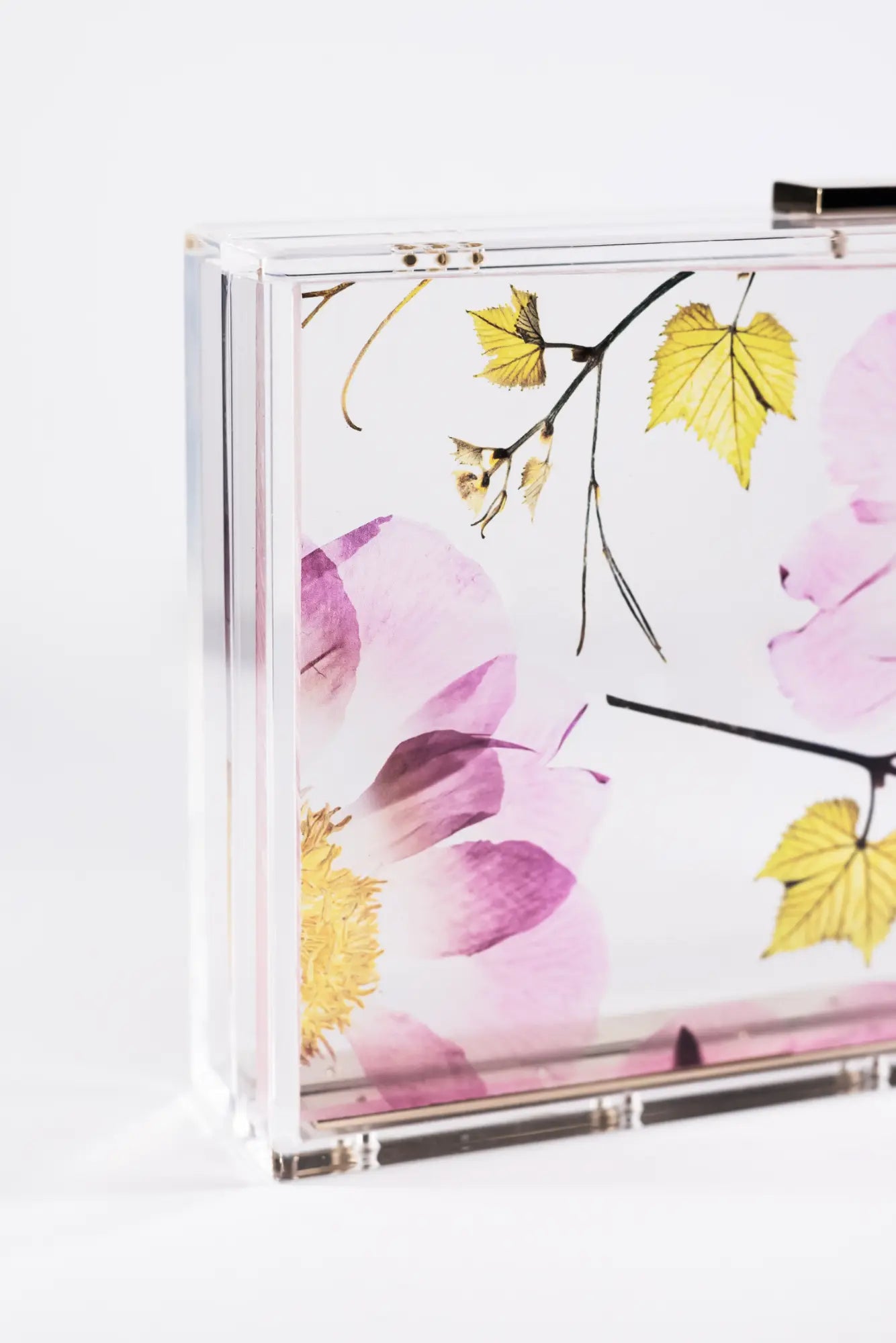 A Mia Acrylic Clutch - Pressed Translucent Floral can be pre-ordered from The Bella Rosa Collection.