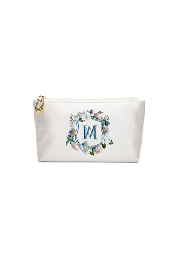 White cosmetic pouch with a The Bella Rosa Collection Hayden Ivory Satin Zipper Pouch with Floral Crest Monogram Embroidery design.