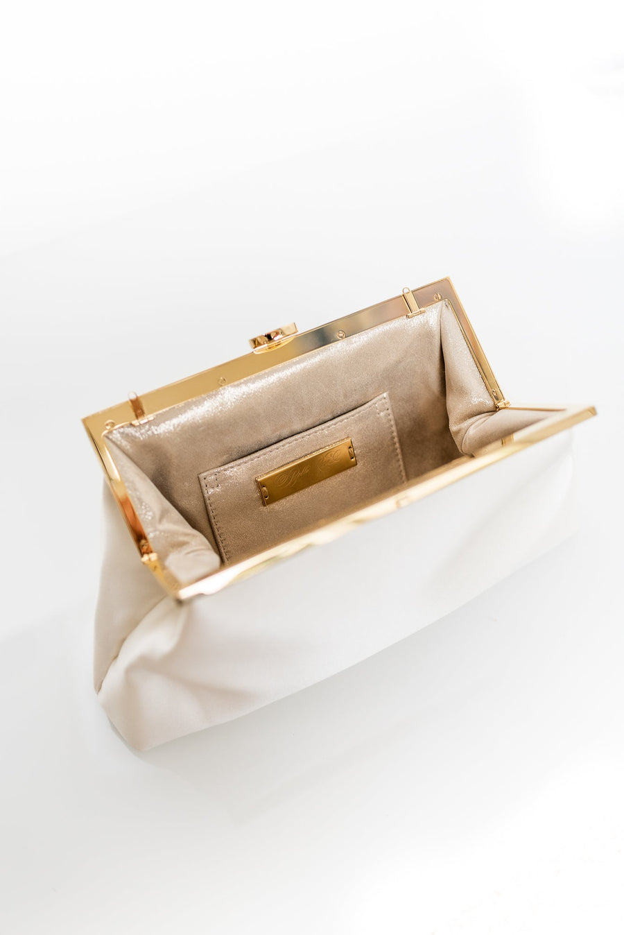 Open view of Rosa Clutch in Ivory white satin with gold hardware clasp frame.