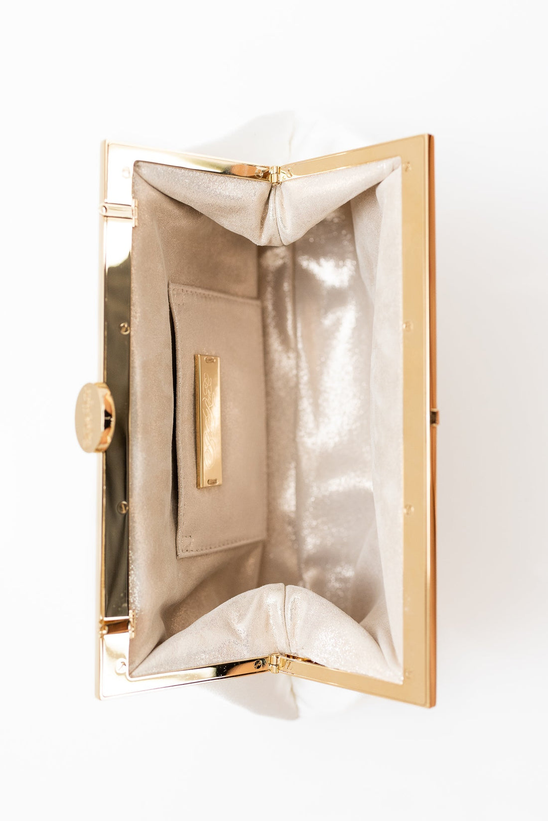 Open view inside Rosa Clutch in Ivory white satin with gold hardware clasp frame.
