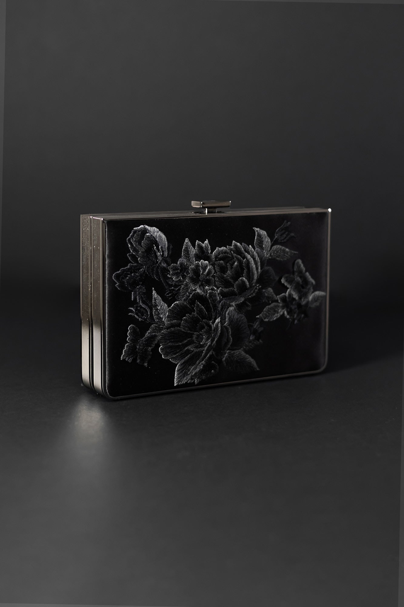 A black purse with Floral Embroidery on it.
Product Name: Venezia Clutch x MICAELA - Black Satin Floral Embroidery
Brand Name: The Bella Rosa Collection