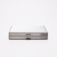 A top view of the Bonansea clutch clasp and frame hardware in silver.