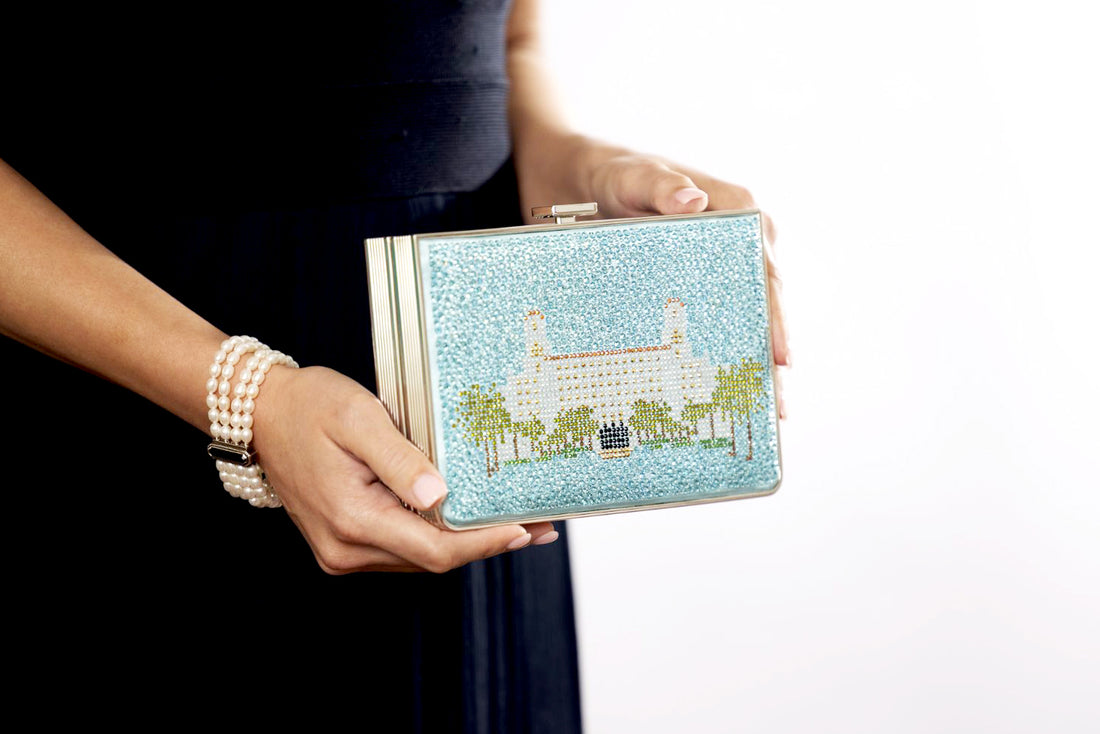 A woman in Palm Beach, Florida is holding a Breakers Crystal Rhinestone Clutch from The Bella Rosa Collection.