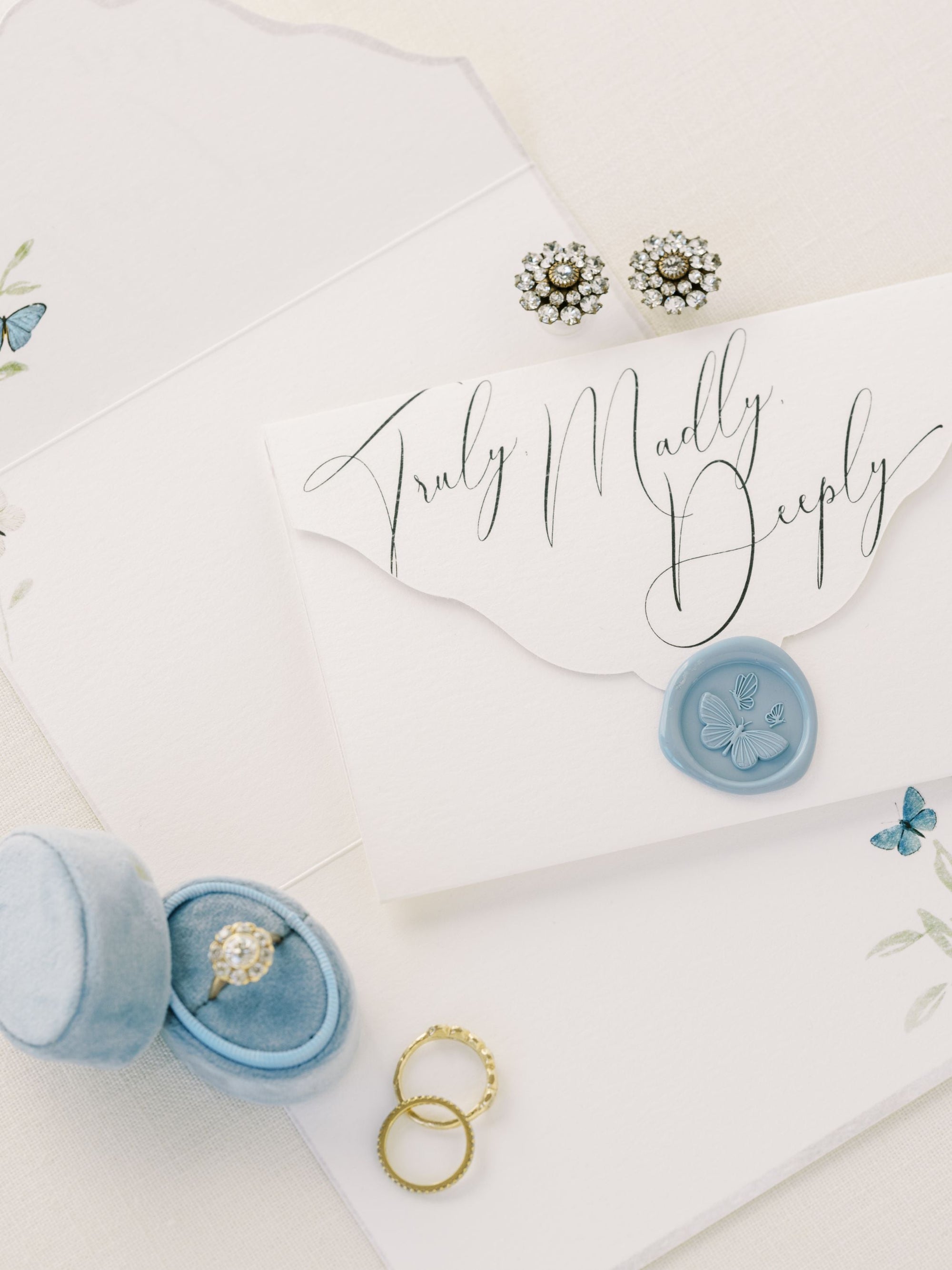 A Wedding Day Love Note Box Stationery Set from The Bella Rosa Collection with a blue ring and a wax seal, perfect for your wedding day stationery.