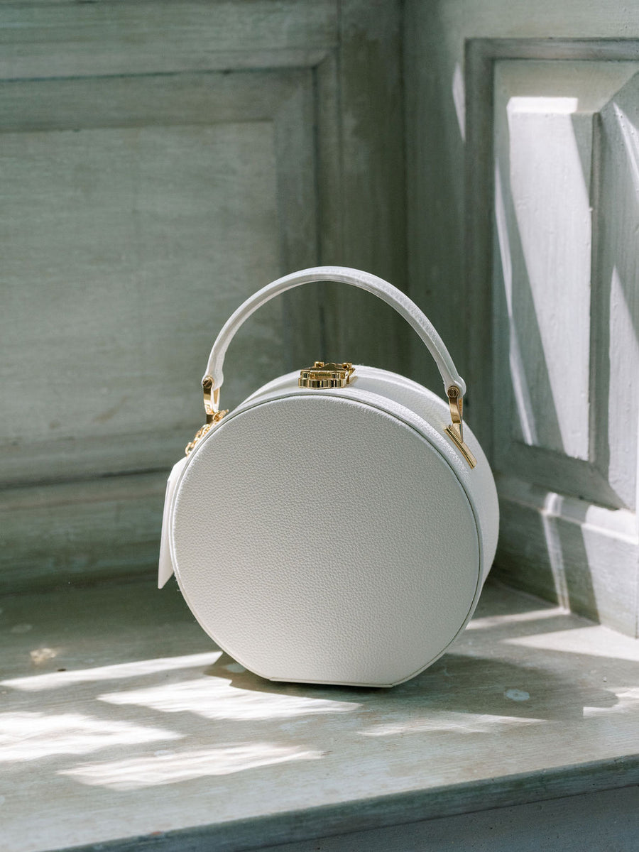 The Original Hat Box Handbag by Joy Proctor and Bella Rosa in White Pebble Leather with Gold Accents.  Edit alt text