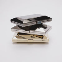 360 view of three Milan clutch with a geometric beveled metal frame in reflective silver, gunmetal and gold.