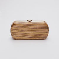 360 View of Bella Clutch with a gold hardware frame in a solid African Zebra Wood Body.