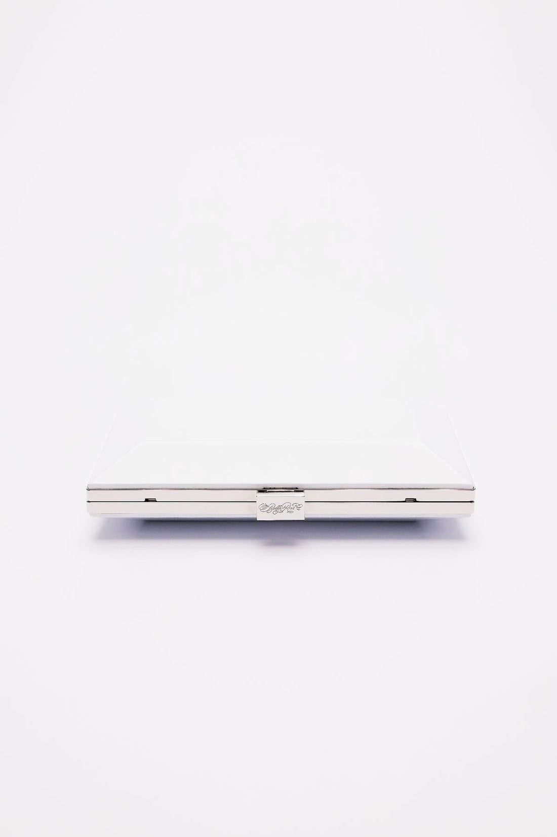 Top closed view of Milan Clutch in pearl white with silver hardware frame.