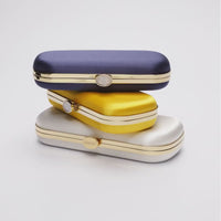 360 view of Three stacked Bella Clutches in Navy Blue, yellow and ivory