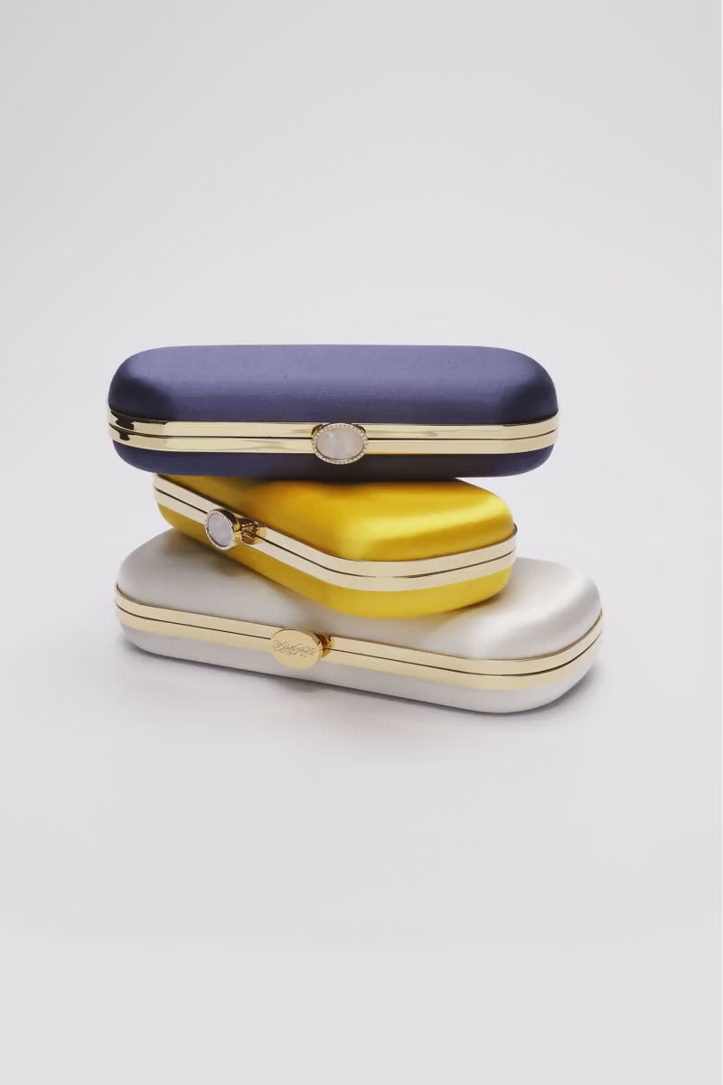 360 view of Three stacked Bella Clutches in Navy Blue, yellow and ivory