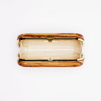 An open, empty The Bella Rosa Collection Bella Clutch African Zebra Wood Petite purse made of sustainably sourced African Zebra Wood with a fabric interior on a white background.