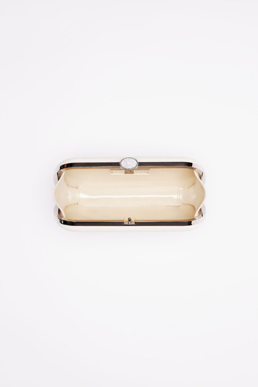 Bella Clutch in a shimmer white glitter body with a silver frame open showing aerial view inside the clutch.