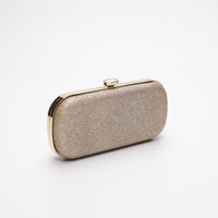 Side angle view of Bella clutch with gold hardware in Champagne Shimmer.