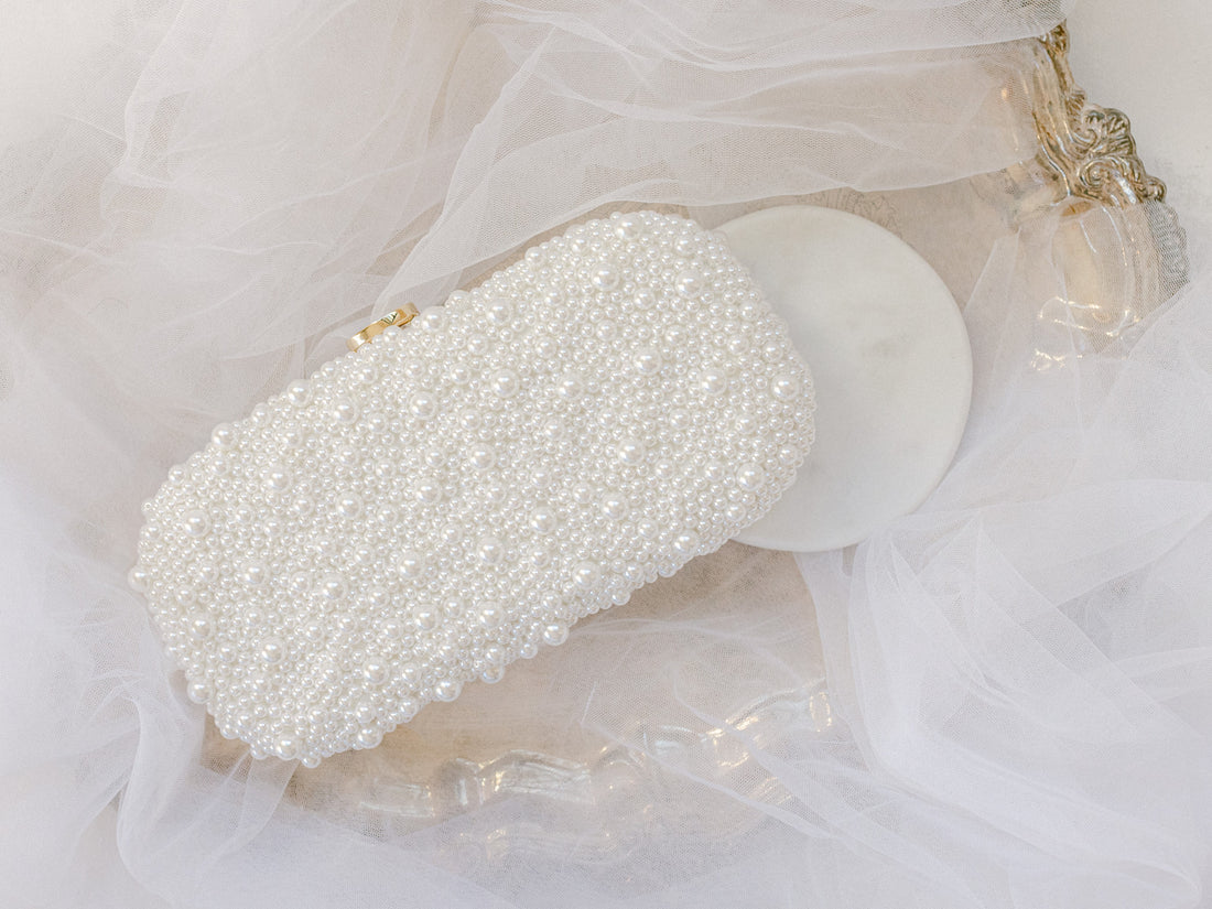 An Over the Moon True Love Bella Pearl Clutch with a chain.