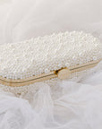 Bella Rosa Collection's True Love Bella Clutch Petite pearl-embellished clutch purse on a tulle fabric background.