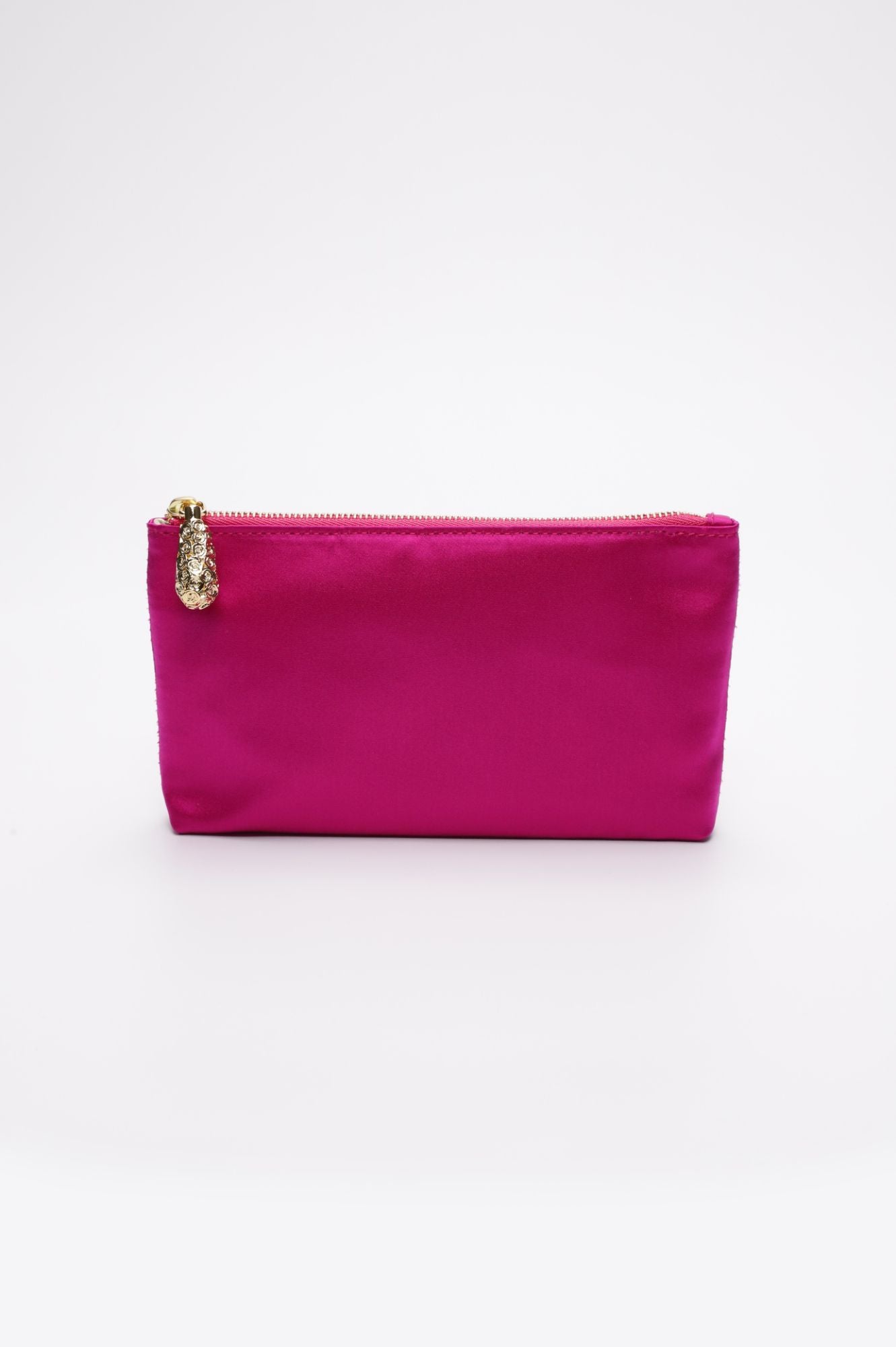 A small, rectangular pouch named the Mia Clutch Clear Acrylic with Hot Pink Satin Zipper Pouch from The Bella Rosa Collection, featuring a bright pink fabric and a gold zipper and pull tab, displayed against a plain white background.