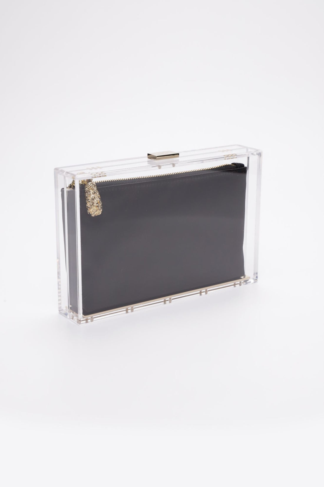 Side angle of the Mia Clutch with a clear acrylic rectangle body with a black satin interior pouch.
