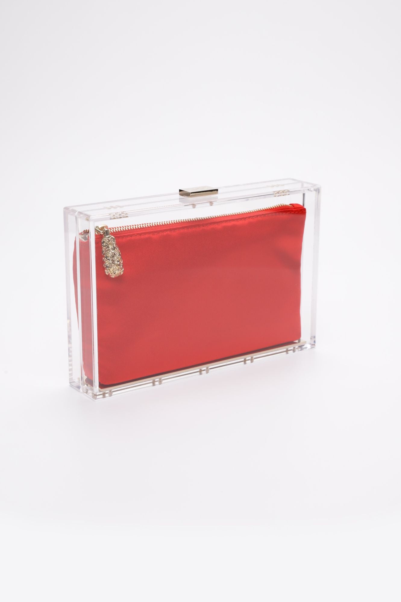 The Bella Rosa Collection's Mia Clutch Clear Acrylic with Red Satin Zipper Pouch - Sample Sale: a rectangular clear acrylic clutch featuring a gold-tone clasp and a detachable red satin pouch inside. This final sale handbag is not to be missed.