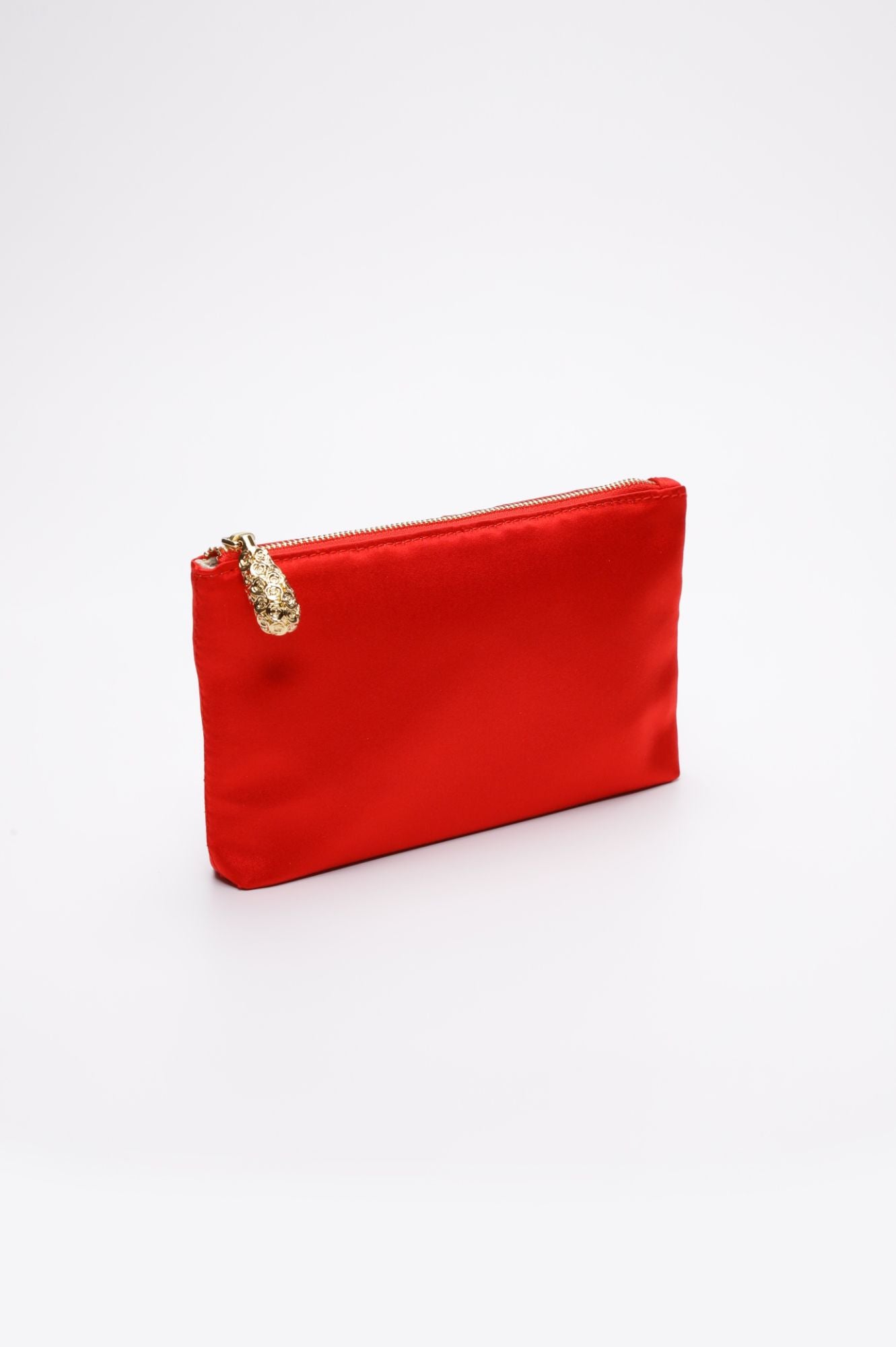 A small, rectangular, clear acrylic clutch featuring a red satin zippered pouch with a gold zipper pull, set against a plain white background. This Mia Clutch Clear Acrylic with Red Satin Zipper Pouch from The Bella Rosa Collection is available as a final sale item in the sample sale.