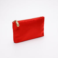 Side angle of Red satin pouch with gold zipper.