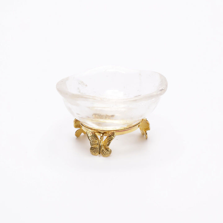 A Clear Rock Crystal Quartz Engagement Ring Dish from The Bella Rosa Collection sitting on top of a metal stand.