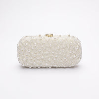 True Love Pearl Clutch with hand-sewn pearls with a gold hardware frame.