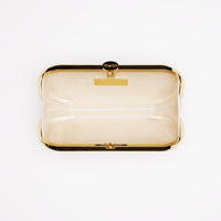 A personalized The Bella Rosa Collection Golden Bella Clutch on a white surface.