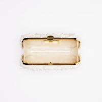 An open, empty The Bella Rosa Collection True Love Pearl Clutch purse against a white background.