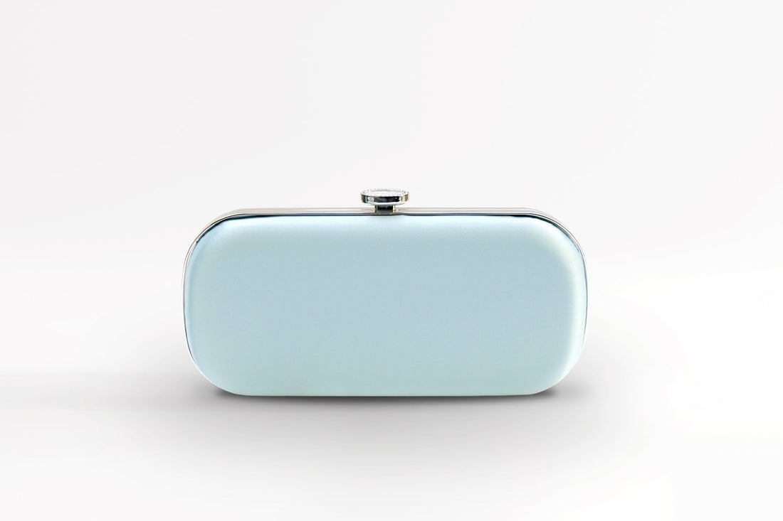 Front view of bridal Bella Clutch in light iced blue with silver hardware accents and stimulated mother of pearl clasp.