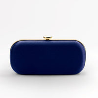 Front view of bridal Bella Clutch in dark navy blue with gold hardware accents and stimulated mother of pearl clasp.