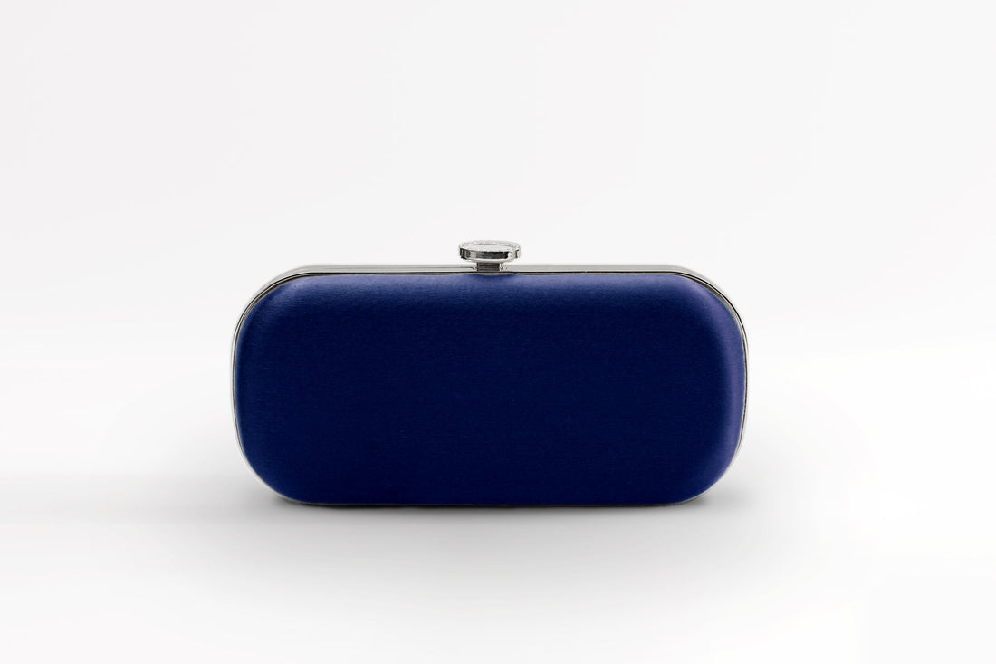 Front view of bridal Bella Clutch in dark navy blue with silver hardware accents and stimulated mother of pearl clasp.