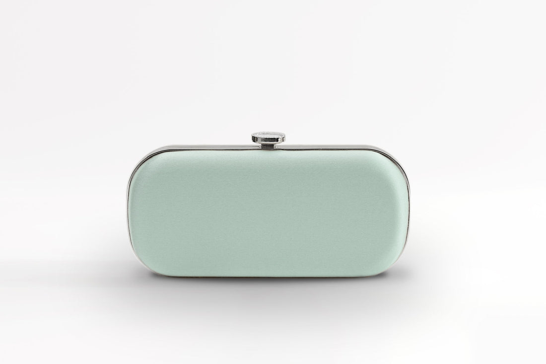 Front view of satin Bella Clutch in sage green satin with silver hardware.