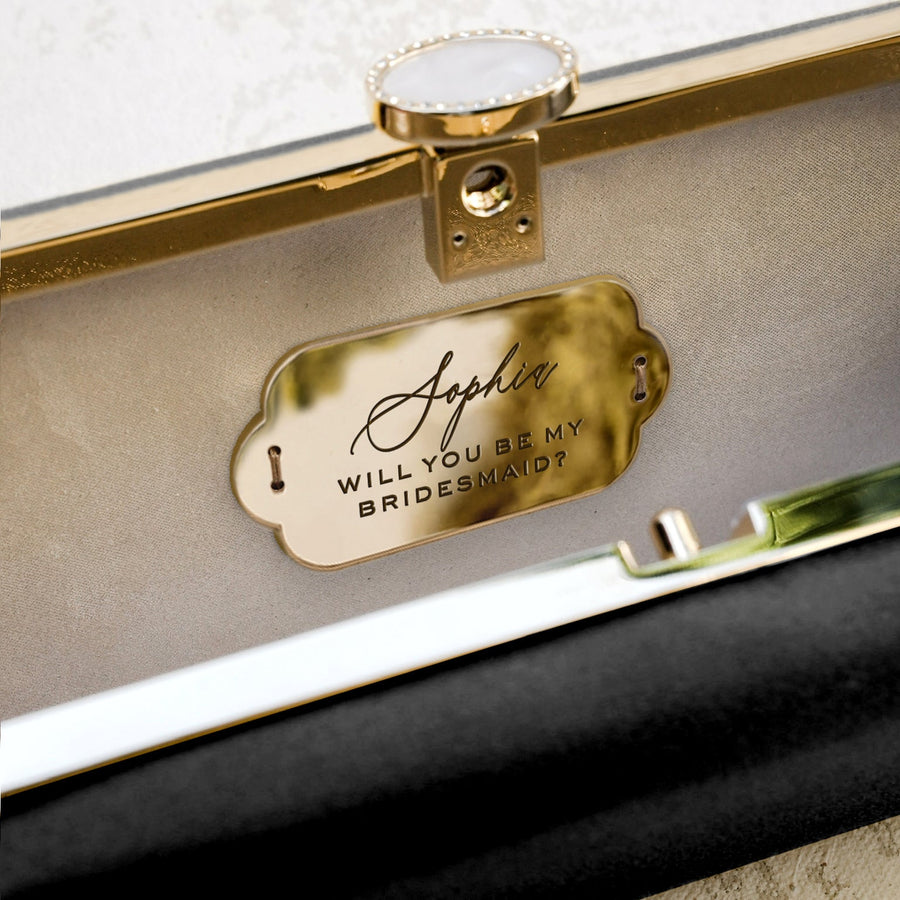 A Black Satin Bella Fiori Clutch from The Bella Rosa Collection with a gold tag.